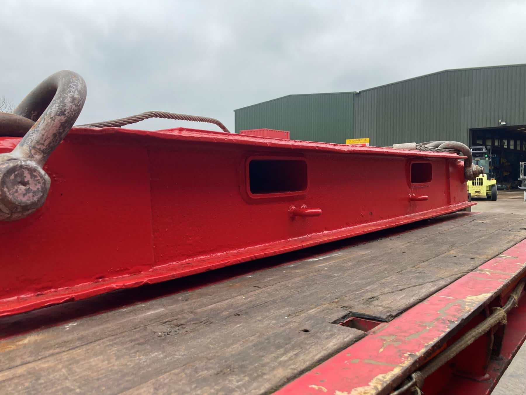 Red lifting cradle used for testing heavy weights at M&M Test Weights.