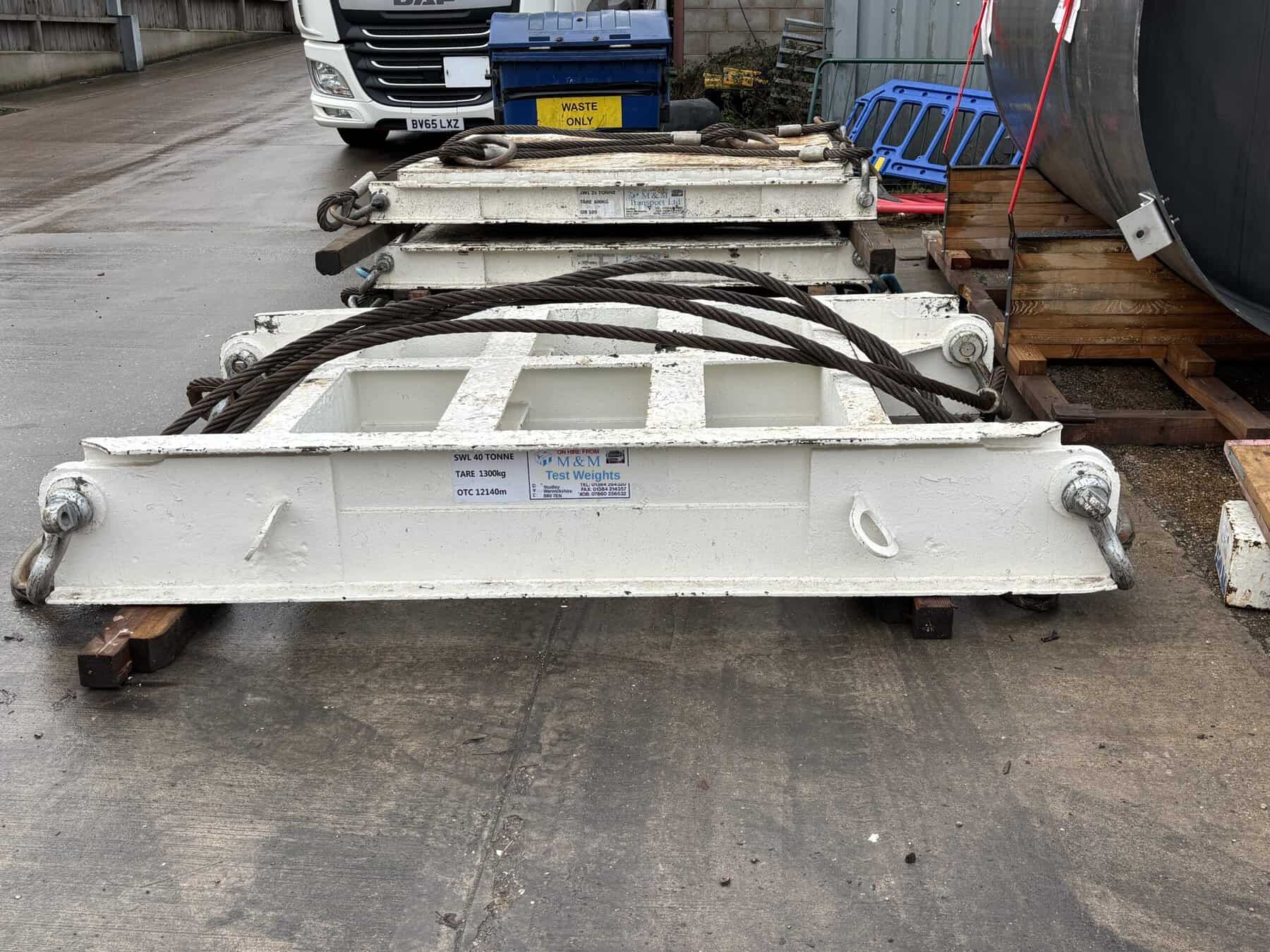 Industrial lifting cradle with cables and metal frame for heavy loads.